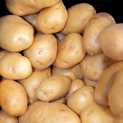 Pile of fresh raw potatoes close-up