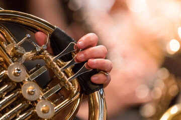 French horn instrument, hands playing horn player in philharmonic orchestra