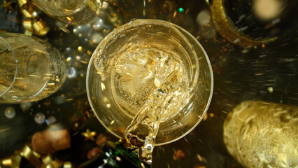 Freeze motion of pouring champagne into flute. Concept of celebration and success.