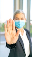 Woman in suit showing stop gesture
