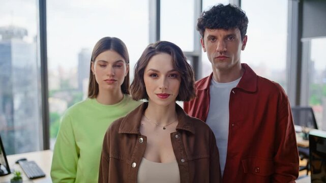 Portrait serious corporate team at cabinet. Focused startupers looking camera