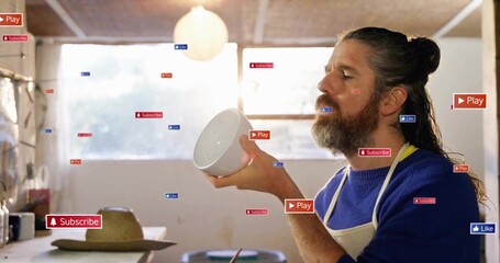 Craftsman in apron holding ceramic bowl in workshop, with Play Subscribe Like overlays, copy space