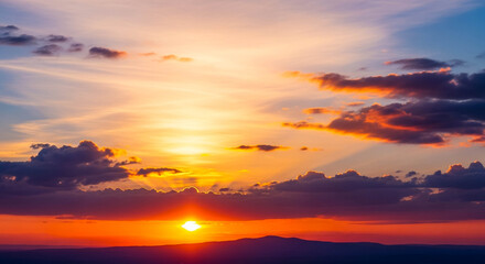 Obraz premium Vivid Sunset Over River and Rolling Hills with Radiant Sky and Silhouetted Trees