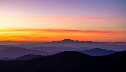 Sunrise over layered mountains
