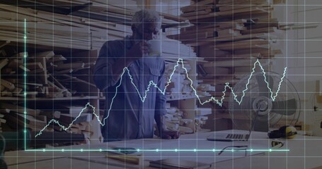Carpenter holding mug and examining blueprints in carpentry workshop with grid, line graph overlay