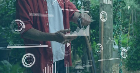 Adult male gripping shovel and gesturing at floating digital overlays in garden, with post rope