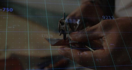 Technician hands wearing shirt positioning metal part on board at bench with numeric grid readouts