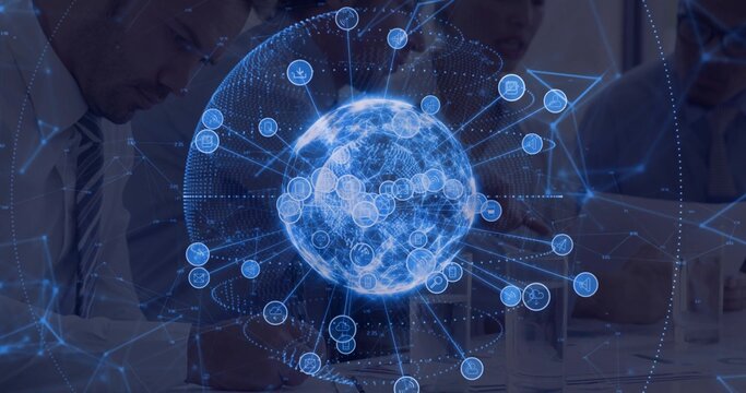 Displaying holographic networked globe above table in conference room, with team typing on laptops