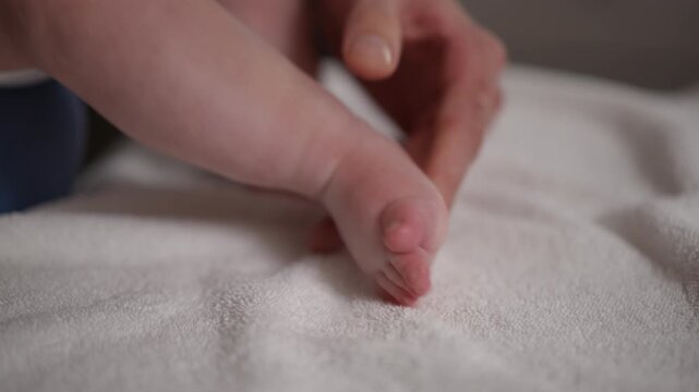 A devoted parent cradles their babys tiny foot, highlighting their profound love and deep connection in this moment