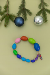 Christmas Medical Instruments with Christmas Tree and blue and silver balls on yellow, Khaki, green Background. New Year's photo of a medical hammer, orchidometer, tuning fork, stethoscope