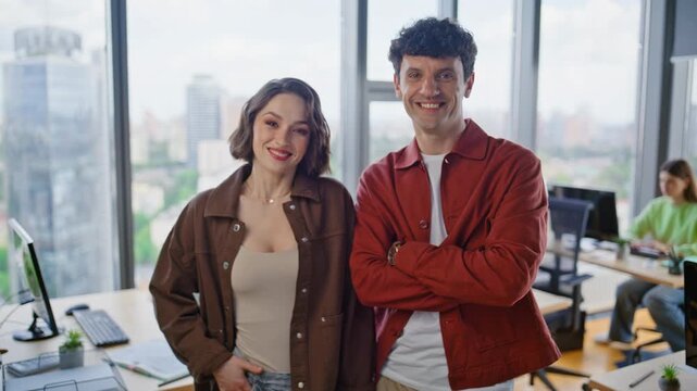 Smiling colleagues posing coworking closeup. Happy engineers looking camera