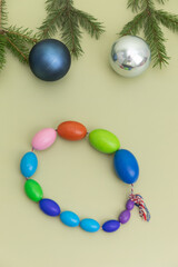 Christmas Medical Instruments with Christmas Tree and blue and silver balls on yellow, Khaki, green Background. New Year's photo of a medical hammer, orchidometer, tuning fork, stethoscope