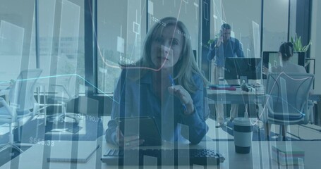 Tapping digital tablet, office woman working in open-plan office, with keyboard, coffee cup