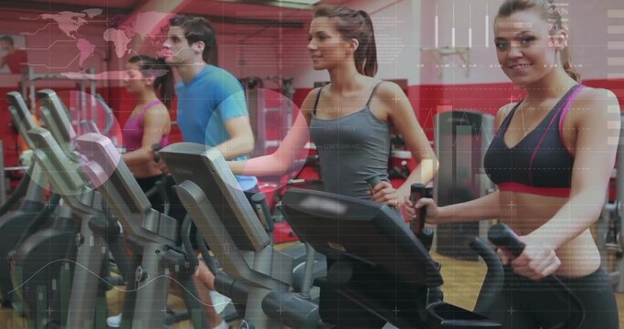 Fototapeta Four exercisers wearing workout clothes working out on ellipticals in gym, with digital consoles