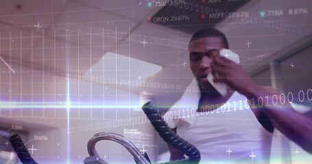 Working towel-draped man in tank-top gripping handles and holding bottle at gym, data overlay