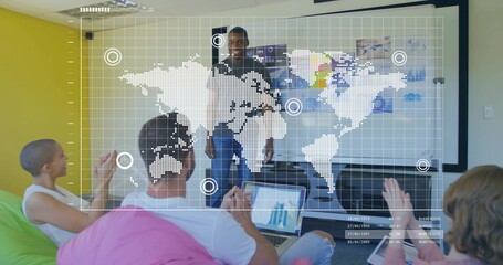 Male presenter presenting data in meeting room, with bean bag chairs and digital world map overlay