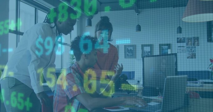Collaborating colleagues leaning and typing at office desk, with laptop, monitor and data overlay