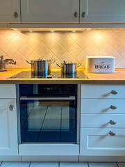 Kitchen scene with stove and pots on top.