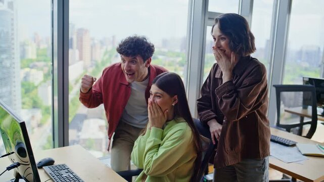 Office winners rejoicing success at agency workplace closeup. Team embracing