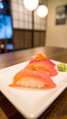 Sushi on white plate, restaurant setting