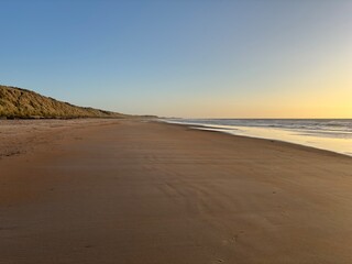 Sunrise over an empty beach in summer