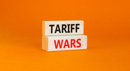 Trade tariff wars symbol. Concept word Tariff wars on beautiful wooden blocks. Beautiful orange paper background. Business trade tariff wars concept. Copy space.