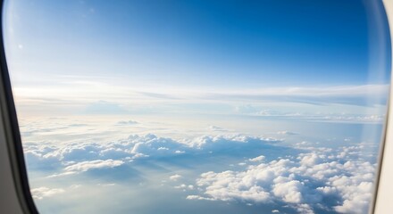 Fototapeta premium View from an airplane window of a vast expanse of clouds and blue sky