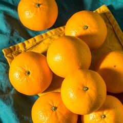 Fresh oranges on a yellow napkin