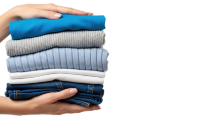 Close-up of female hands gently holding a neat stack of folded blue, grey, white laundry on transparent background with copy space, concept of pristine domestic organization