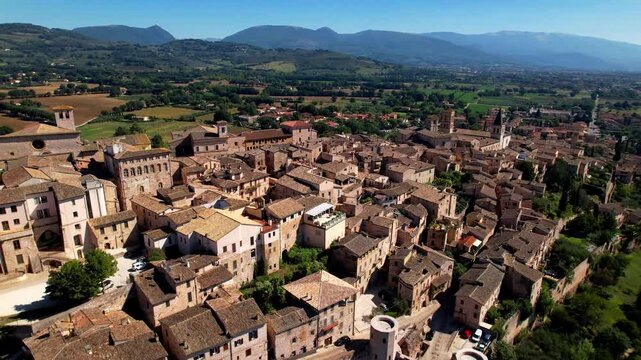 Italy tourism, Umbria region most scenic villages (borgo) - Spello - splendid medieval town and countryside scenery.  aerial drone video 4k hd