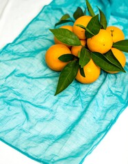 Fresh oranges on teal fabric