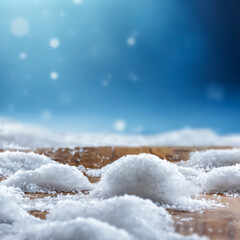 Wooden surface covered with snow with empty copy space for product placement with blurred dark blue frosty winter snowing background. Seasonal advertising, nature, winter concept.