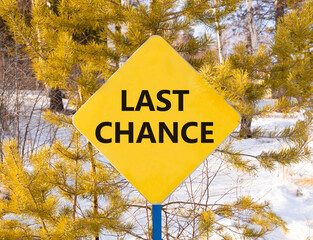 Last chance symbol. Concept word Last chance on beautiful yellow road sign. Beautiful snow winter...