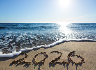 New Year 2026, lettering on the beach sand.