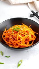 Vibrant carrot noodles in bowl