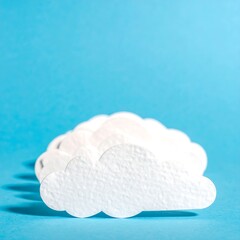 White clouds on a bright blue background