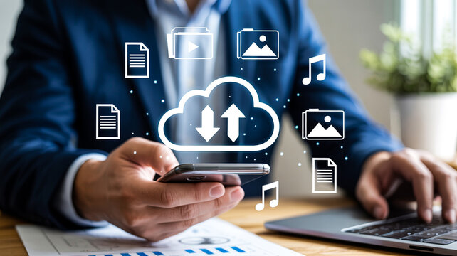 Businessman using cloud technology on smartphone and laptop for data transfer