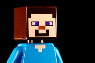 Obraz premium Side view of LEGO Minecraft Steve face closeup on a black background