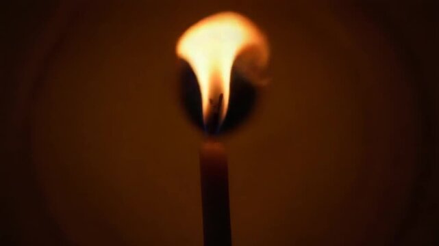 Birthday candles burning in the dark. Burning candle wick flame