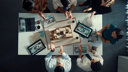 Top view of manager shaking hand and clapping hands to celebrate project. Aerial view of architect...