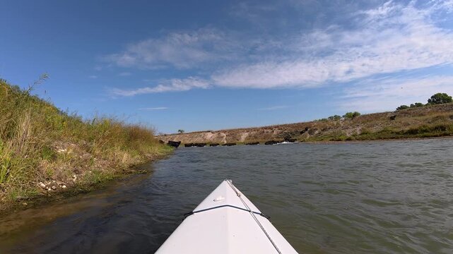 Niobrara National Scenic River in Nebraska Sandhills - POV from kayak or canoe from upstream paddling in late summer with cattle crossing the river