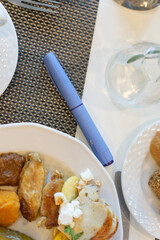Diabetes medication pen Ozempic and plates of healthy food on a table, concept of diabetes management, weight loss, chronic illness