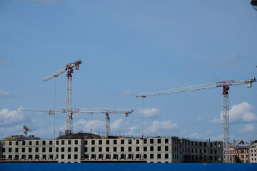 construction cranes and building walls