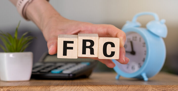 Fed Rate Cut text concept, FRC text on wooden cube, business and financial concept
