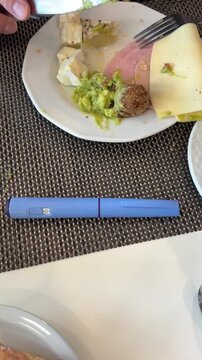 Medical injection pen Ozempic next to a plate of a healthy meal on a dining table, concept of diabetes management, health, dieting