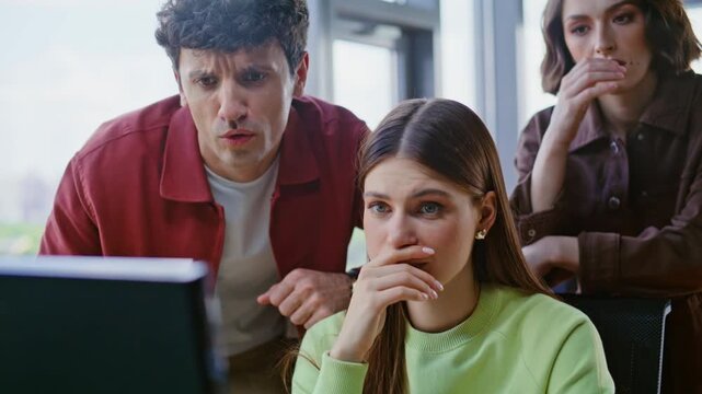 Group startupers having problems office closeup. Upset coworkers looking laptop