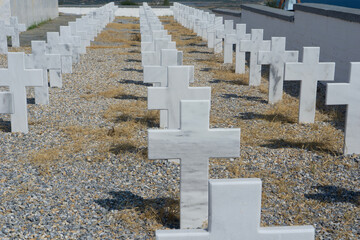 Rows of identical white crosses in a military cemetery in Greece, symbolizing remembrance, orthodox...