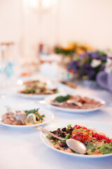 Elegant Dining Table with Assorted Plates and Fresh Gourmet Dishes