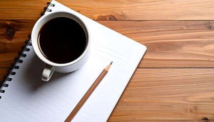 Coffee, notebook, and pencil on a wooden table