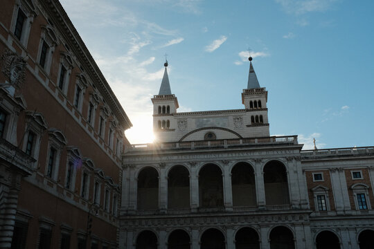 Archbasilica of Saint John Lateran facade and Lateran district with piazza palace and Porta San Giovanni ancient walls Rome Italy exterior architecture landmark. High quality photo